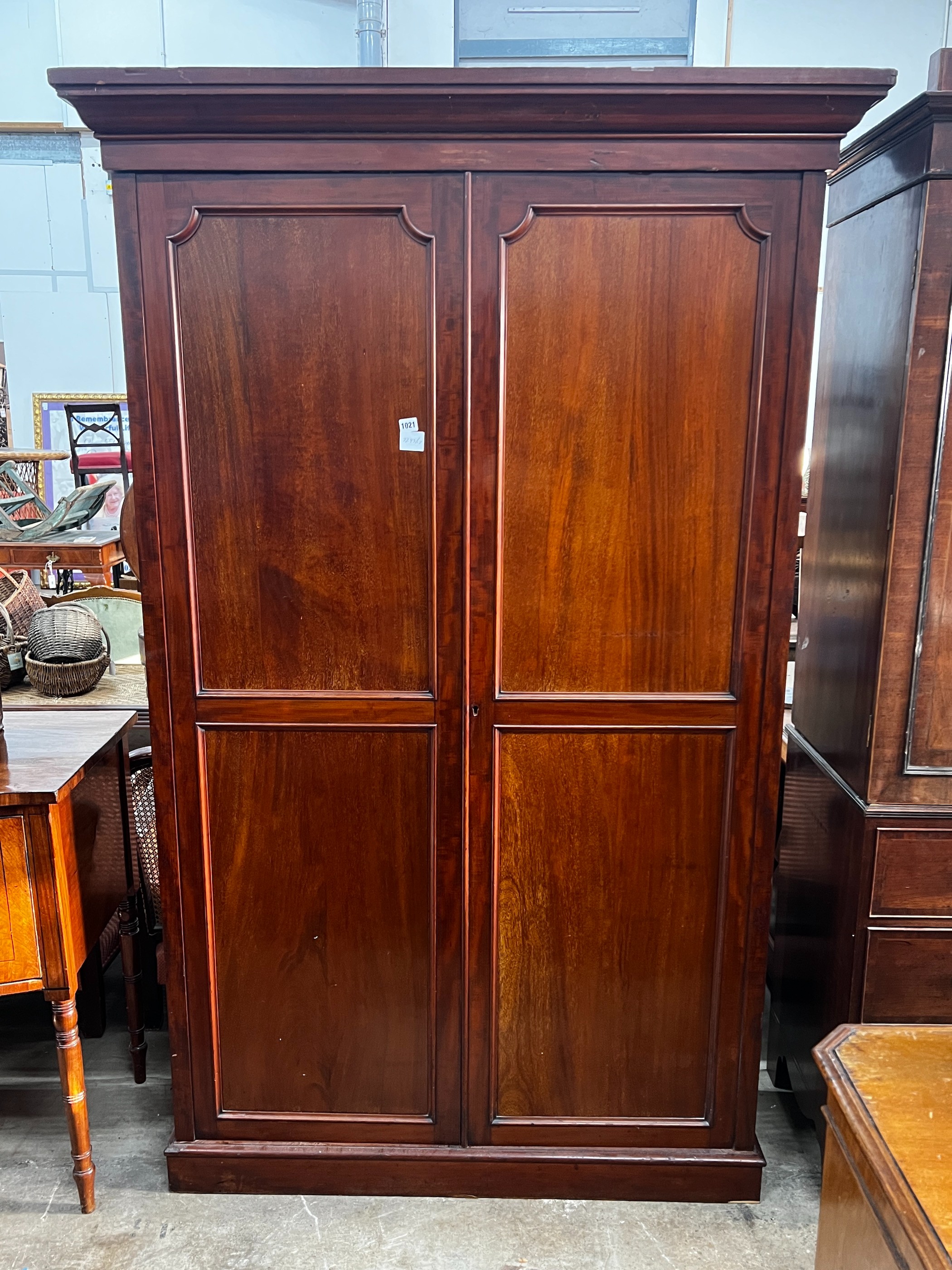 An early 20th century George III style panelled mahogany wardrobe, length 132cm, depth 42cm, height 210cm
